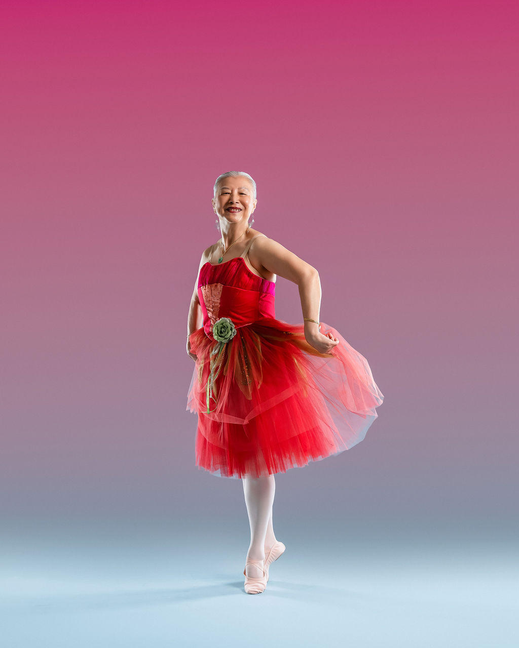 Young dancer in a red tutu on pointe