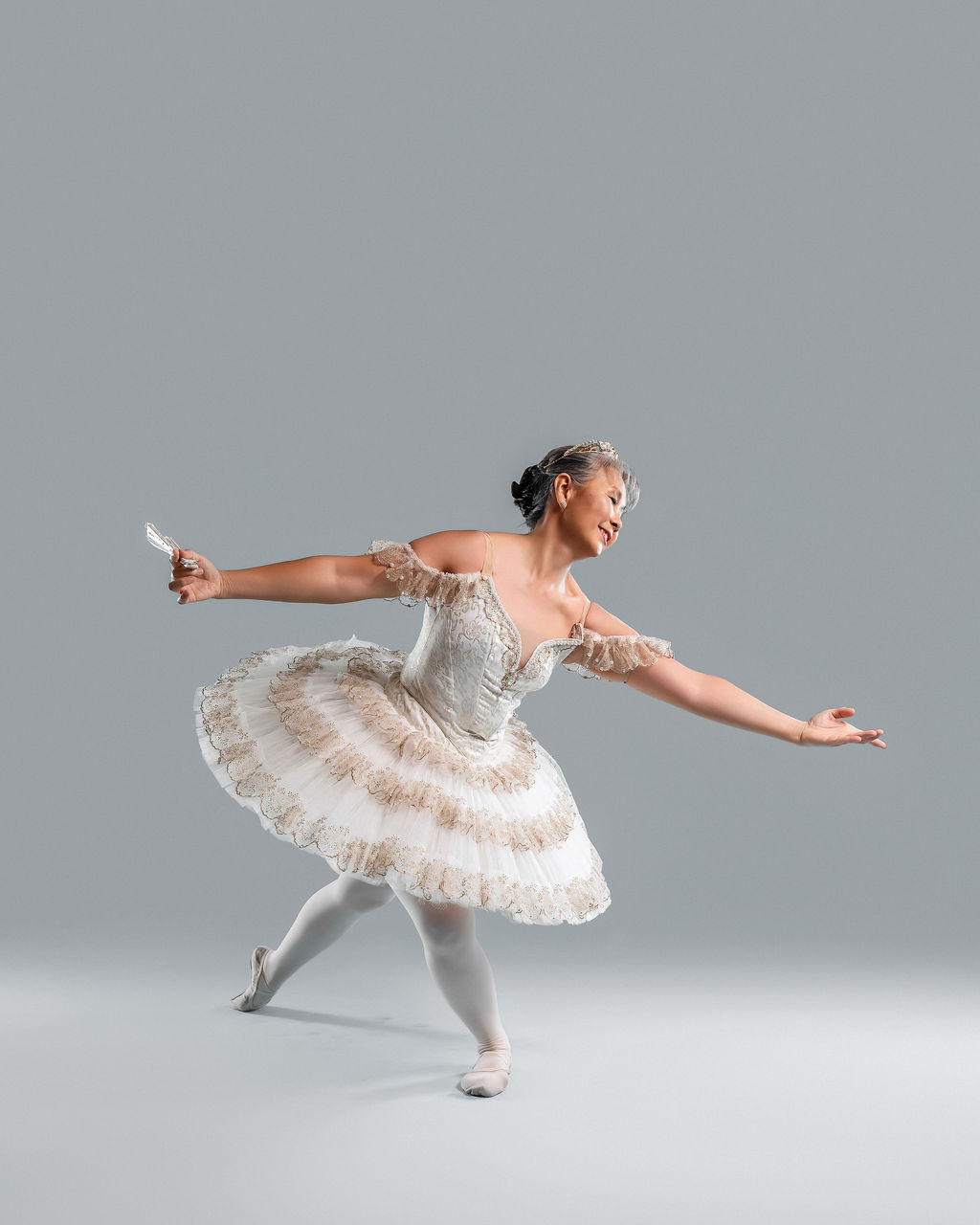 Dancer in a dynamic pose with a fan