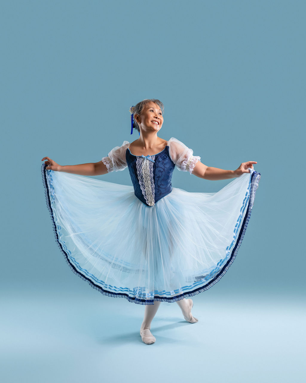 Dancer smiling while twirling her skirt