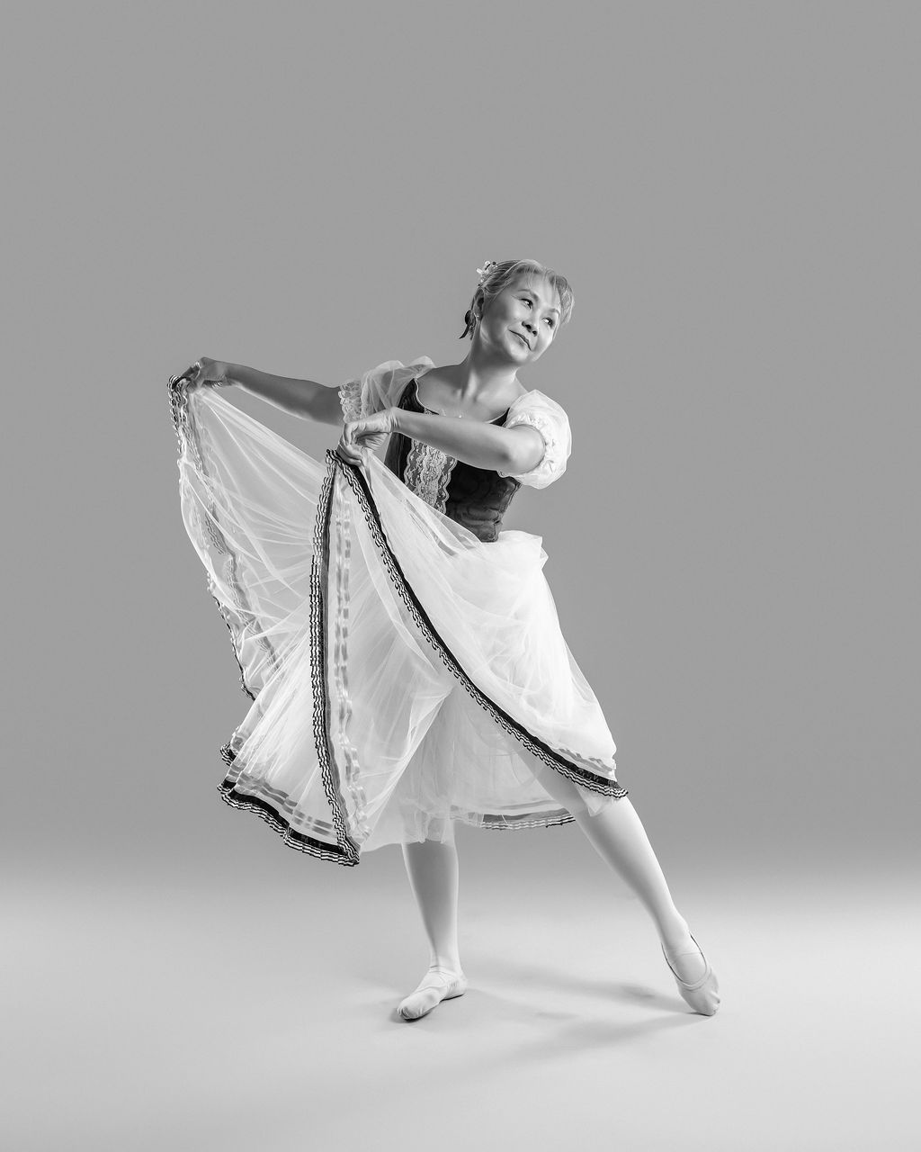 Dancer in a dramatic pose with flowing white fabric