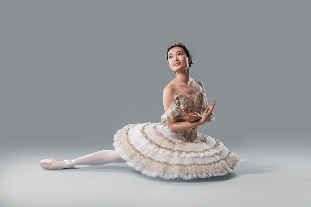 Dancer seated in an ornate tutu