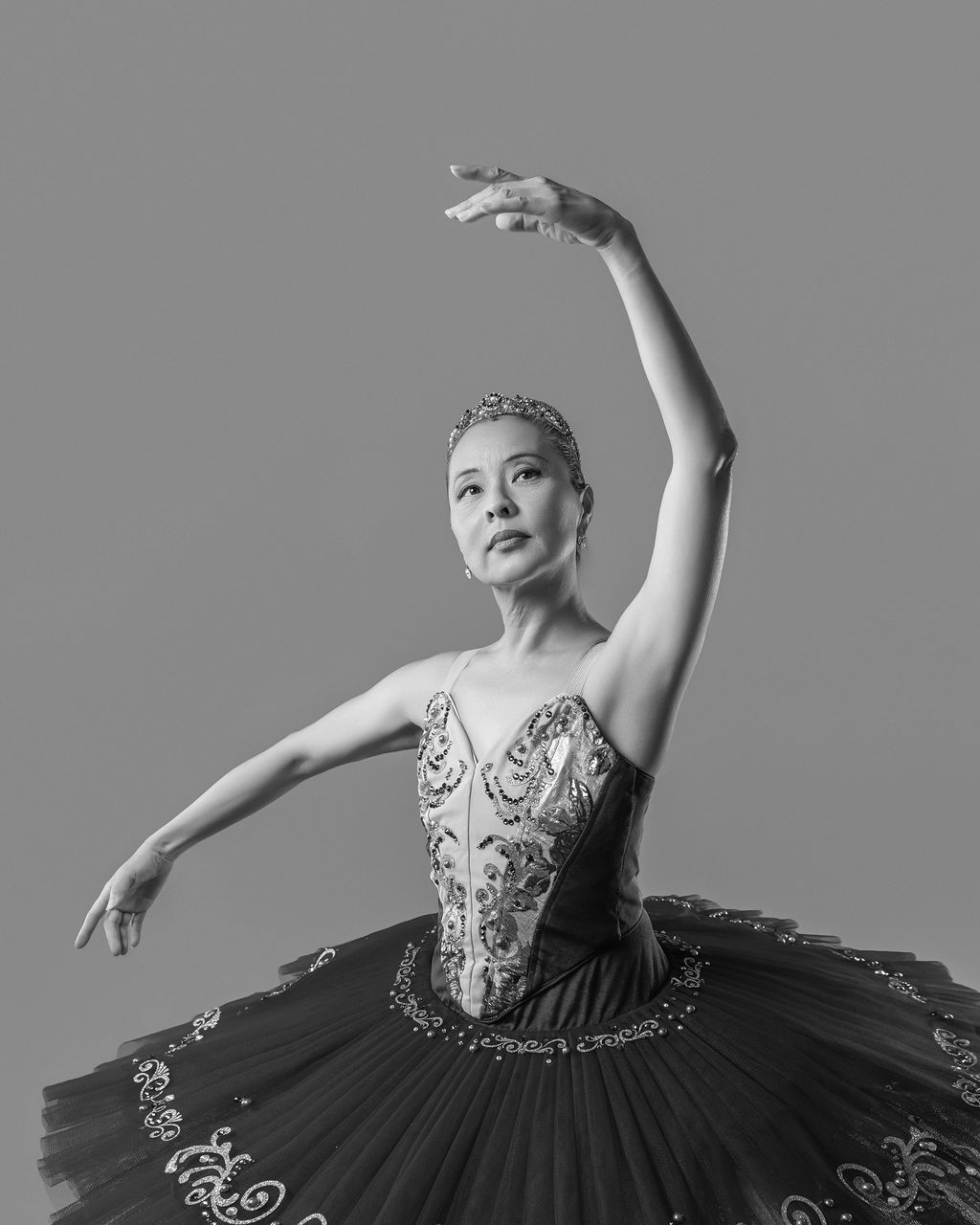 Dancer in a black tutu, arm raised