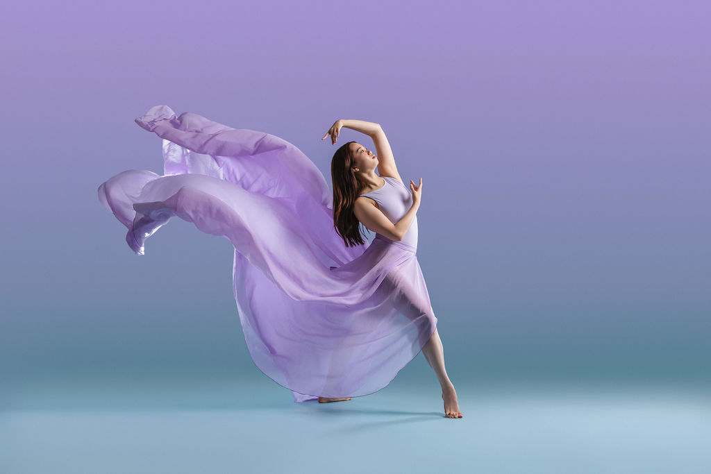 Junior dancer on gradient backdrop